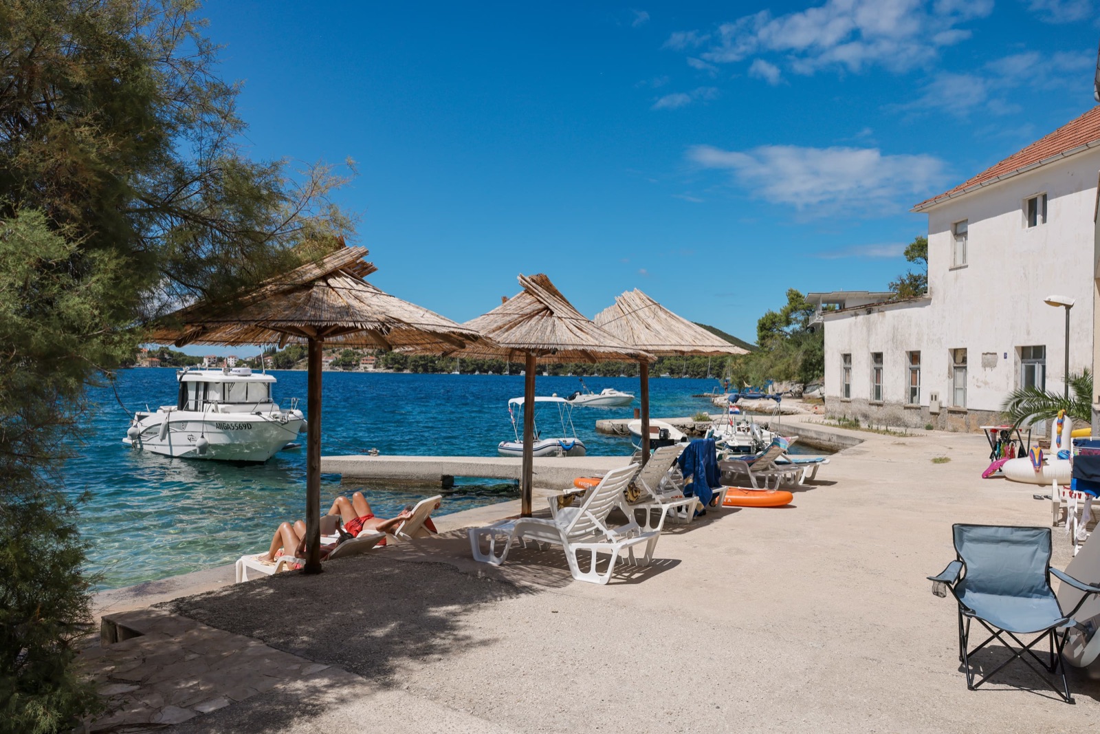 Sun loungers where the terrace meets the sea