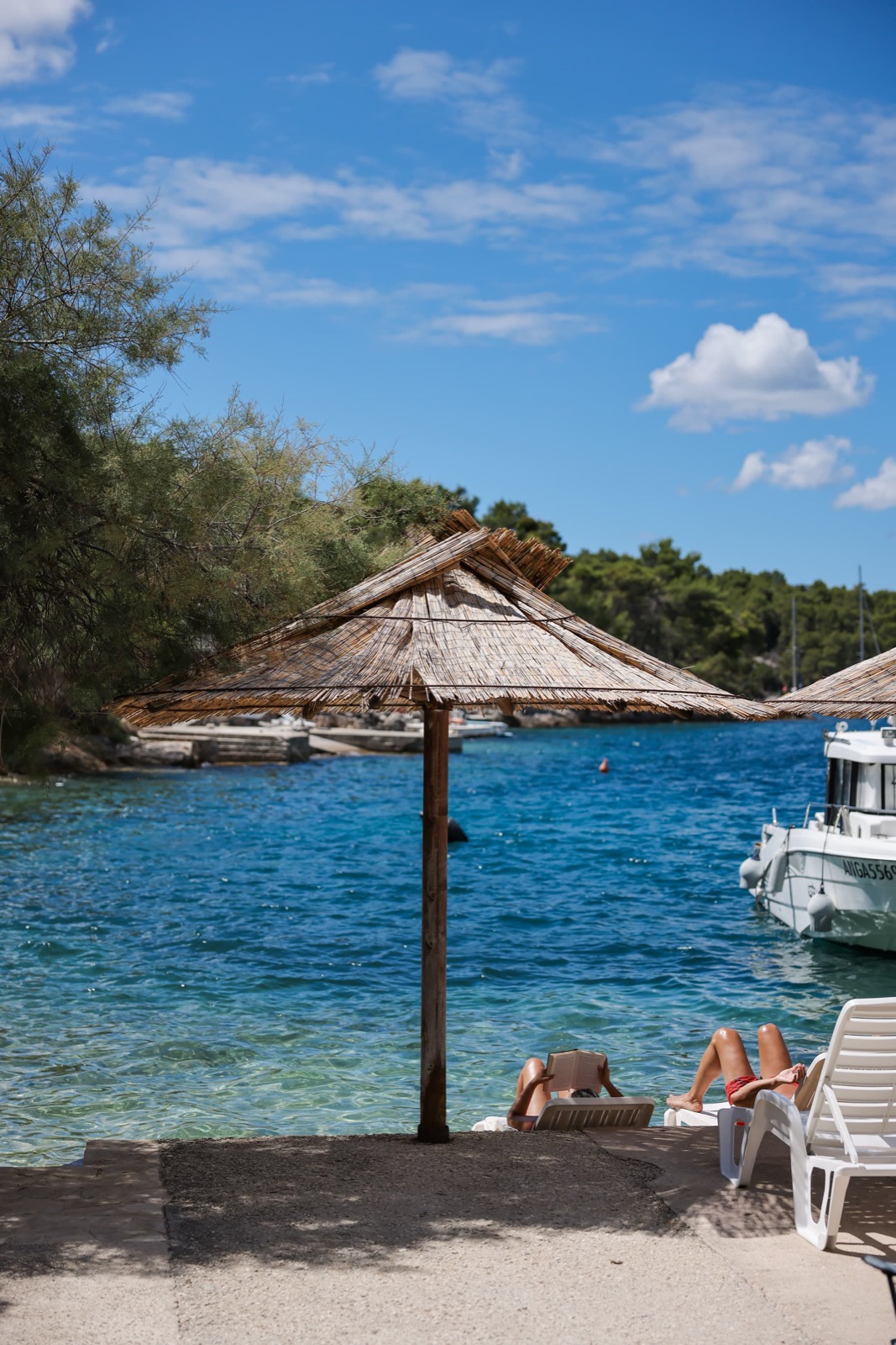 A shaded lounger at the water's edge